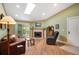Cozy living room with hardwood floors, a stone fireplace, and a sliding door to the balcony at 8225 Fairmount Dr # 10-203, Denver, CO 80247