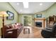 Bright living room featuring hardwood floors, fireplace, and sliding glass doors to a balcony at 8225 Fairmount Dr # 10-203, Denver, CO 80247