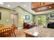 Open concept living room featuring vaulted ceilings, hardwood floors, fireplace and dining area at 8225 Fairmount Dr # 10-203, Denver, CO 80247
