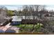 Aerial view of backyard featuring mature trees, lush grass, and a charming garden shed at 921 S Wheeling St, Aurora, CO 80012