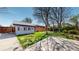 A spacious backyard and patio are framed by mature trees, offering shade and privacy at 921 S Wheeling St, Aurora, CO 80012