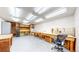 Spacious basement with fluorescent lighting, wooden workbenches, and ample storage space at 921 S Wheeling St, Aurora, CO 80012