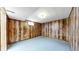 Basement features wood paneled walls, durable flooring, and a small window at 921 S Wheeling St, Aurora, CO 80012