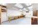 Large basement with workbenches, shelving, and ample lighting at 921 S Wheeling St, Aurora, CO 80012