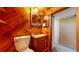 Bathroom featuring warm wood tones, a classic toilet, and a vanity at 921 S Wheeling St, Aurora, CO 80012