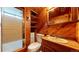 Bathroom featuring warm wood tones, an enclosed shower, and built-in storage shelves at 921 S Wheeling St, Aurora, CO 80012