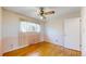 Bright bedroom with hardwood floors, ceiling fan, and a window offering natural light at 921 S Wheeling St, Aurora, CO 80012