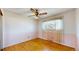 Charming bedroom with hardwood floors, a ceiling fan, and a window with lace curtains at 921 S Wheeling St, Aurora, CO 80012