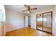 Bedroom with hardwood floors, a ceiling fan, and a mirrored closet enhancing space at 921 S Wheeling St, Aurora, CO 80012