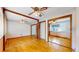 Cozy bedroom featuring hardwood floors, mirrored closet doors, and a ceiling fan at 921 S Wheeling St, Aurora, CO 80012