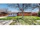 Charming home featuring a blue sunroom, brick accents, and a well-manicured front lawn at 921 S Wheeling St, Aurora, CO 80012