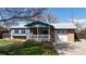Charming single-Gathering home featuring a brick exterior, a cozy front porch with a white picket fence, and a well-manicured lawn at 921 S Wheeling St, Aurora, CO 80012