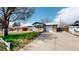 Charming single-Gathering home featuring a brick exterior, a cozy front porch with a white picket fence, and a long driveway at 921 S Wheeling St, Aurora, CO 80012