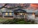 Charming single-Gathering home featuring a brick exterior, a cozy front porch with a white picket fence, and a well-manicured lawn at dusk at 921 S Wheeling St, Aurora, CO 80012