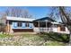 Charming single-Gathering home featuring a brick exterior, a cozy front porch with a white picket fence, and a well-manicured lawn at 921 S Wheeling St, Aurora, CO 80012
