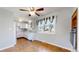 Eat-in kitchen features white cabinets, ceiling fan, and a large window at 921 S Wheeling St, Aurora, CO 80012