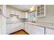 Bright kitchen with white cabinets and countertops at 921 S Wheeling St, Aurora, CO 80012