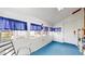Bright sunroom with white walls and blue carpet featuring lots of natural light at 921 S Wheeling St, Aurora, CO 80012