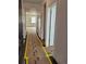Bright hallway showcasing the home's layout and access to various rooms, with wood flooring at 6065 Caribou Dr, Brighton, CO 80601