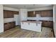 Spacious kitchen with ample wooden cabinetry, a large island, and subway tile backsplash at 6065 Caribou Dr, Brighton, CO 80601