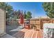 Private backyard with a wood deck, grill, chair, and a wood fence at 9640 W Chatfield Ave # F, Littleton, CO 80128