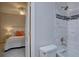 Modern bathroom with tiled shower and bathtub, adjacent to a bedroom at 16397 Sheridan Dr, Parker, CO 80134