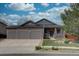 Charming single-Gathering home featuring a three-car garage, stone accents, and a well-maintained front yard at 16397 Sheridan Dr, Parker, CO 80134