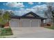 Spacious three-car garage providing ample parking and storage space, complimenting the home's exterior at 16397 Sheridan Dr, Parker, CO 80134