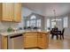 Bright kitchen with granite countertops and stainless steel appliances leading to a dining and living area at 16397 Sheridan Dr, Parker, CO 80134