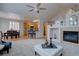 Open floor plan showcasing a cozy fireplace, dining area, and modern kitchen at 16397 Sheridan Dr, Parker, CO 80134