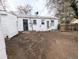 Home's backyard featuring full privacy fence and a rear entry door into the home at 2696 S Grove St, Denver, CO 80219