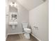 Modern half-bathroom with stylish hexagon flooring, floating sink, and brushed nickel fixtures at 9445 W 58Th Cir # C, Arvada, CO 80002