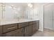 Bathroom boasts double vanity with white countertop and dark wood cabinetry at 9445 W 58Th Cir # C, Arvada, CO 80002