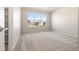 Bright bedroom featuring a large window and neutral carpet at 9445 W 58Th Cir # C, Arvada, CO 80002