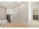 Bright hallway with carpet flooring, white trim, and neutral paint at 9445 W 58Th Cir # C, Arvada, CO 80002