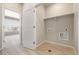 Functional laundry room with tile flooring, washer/dryer hookups and storage shelf at 9445 W 58Th Cir # C, Arvada, CO 80002