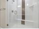 Modern shower with glass door, white subway tile, and mosaic tile accent at 9445 W 58Th Cir # C, Arvada, CO 80002