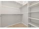 Walk-in closet featuring built-in shelving and hanging rods at 9445 W 58Th Cir # C, Arvada, CO 80002