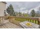 Inviting back deck, perfect for outdoor dining with a sunny sunflower decoration on the picnic table at 9689 W Chatfield Ave # H, Littleton, CO 80128