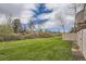 Expansive green backyard offering privacy with ample lawn space and natural landscaping at 9689 W Chatfield Ave # H, Littleton, CO 80128