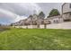 Well-maintained backyard featuring lawn, privacy fences, and townhome exteriors at 9689 W Chatfield Ave # H, Littleton, CO 80128