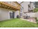 Backyard with patio, turf, outdoor furniture, grill, and fence at 9689 W Chatfield Ave # H, Littleton, CO 80128