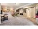 Finished basement space with carpet, built in shelves, green couch and lighting at 9689 W Chatfield Ave # H, Littleton, CO 80128