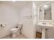 Bathroom featuring vanity with pedestal sink, toilet, mirror and tile flooring at 9689 W Chatfield Ave # H, Littleton, CO 80128