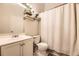 Bathroom with shower, vanity, toilet, shelves and neutral colored walls at 9689 W Chatfield Ave # H, Littleton, CO 80128