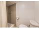 Bathroom featuring shower, toilet, and neutral colored walls at 9689 W Chatfield Ave # H, Littleton, CO 80128