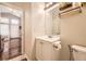 Bathroom featuring modern vanity, toilet, mirror and decorative shelves at 9689 W Chatfield Ave # H, Littleton, CO 80128