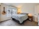 Cozy bedroom featuring a guitar on the wall, ample natural light, and comfortable furnishings at 9689 W Chatfield Ave # H, Littleton, CO 80128