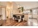 Cozy dining area features built-in seating, hardwood floors, and stylish lighting at 9689 W Chatfield Ave # H, Littleton, CO 80128