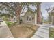 Charming home exterior showcasing a well-maintained yard and mature tree in a quiet neighborhood at 9689 W Chatfield Ave # H, Littleton, CO 80128